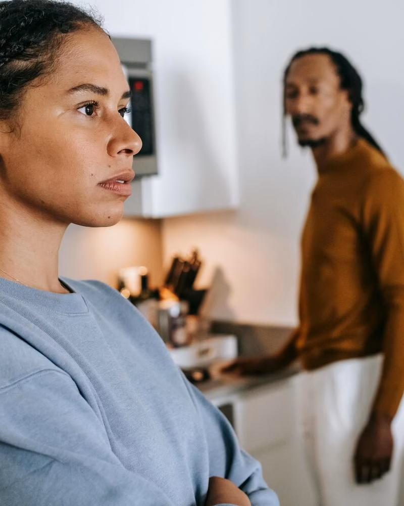 Woman looking away during a tense conversation with her partner at home