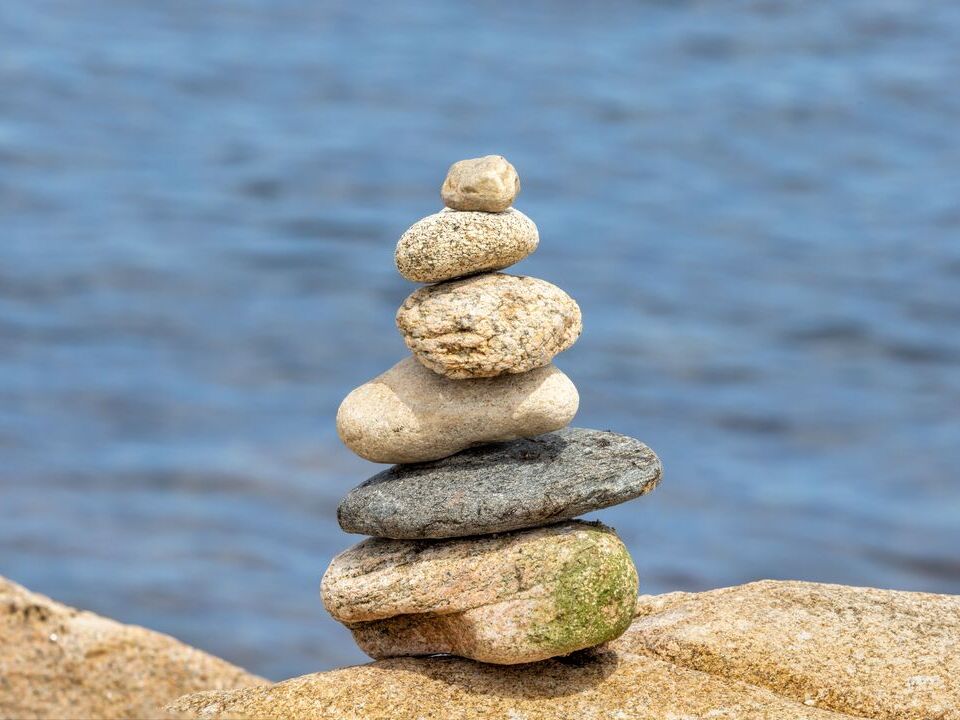 Stack of balanced stones beside the water