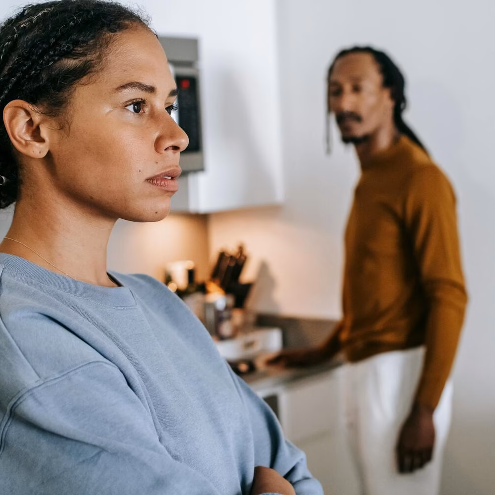 Woman looking away during a tense conversation with her partner at home