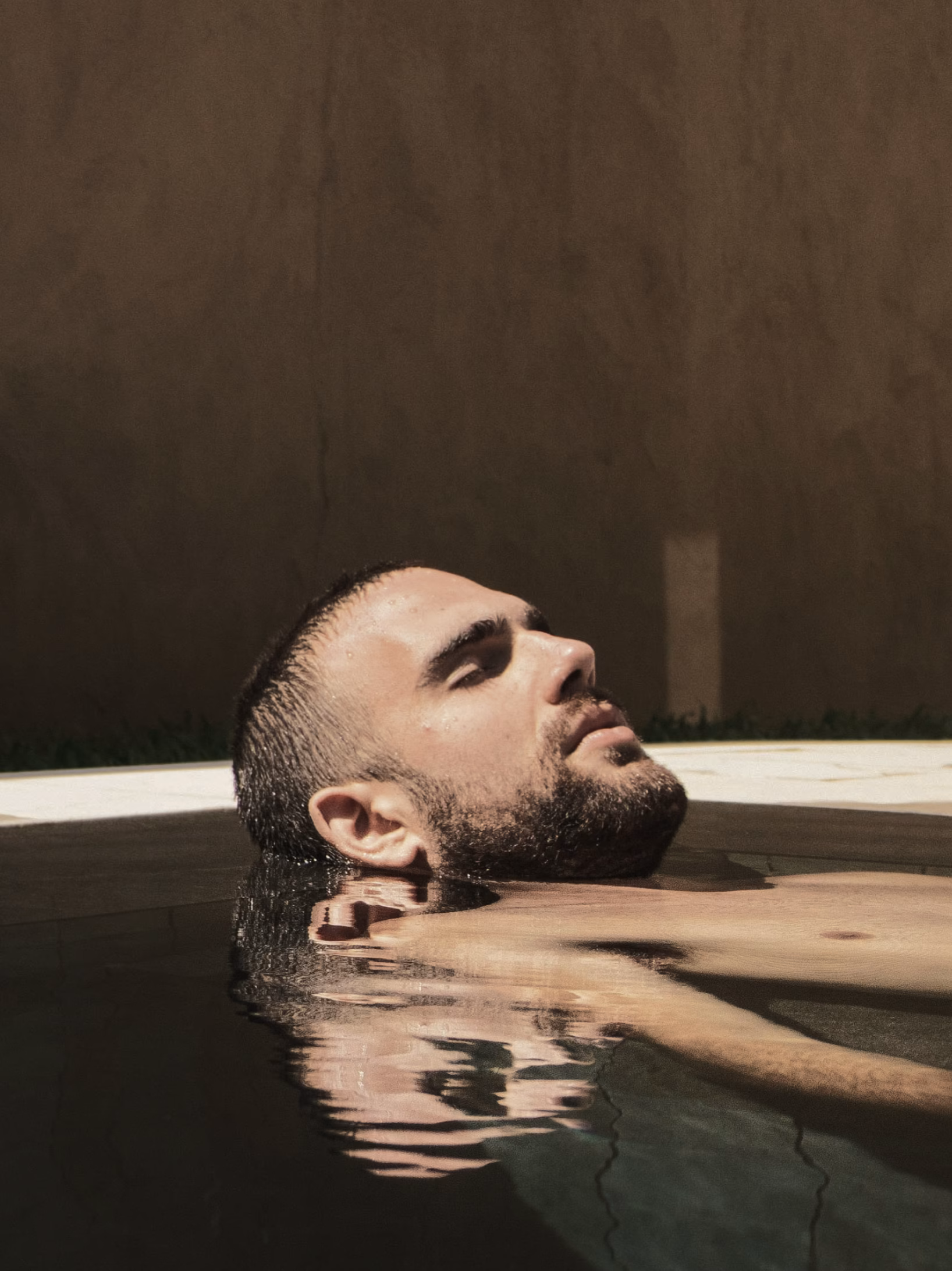 Man floating peacefully in a heated pool