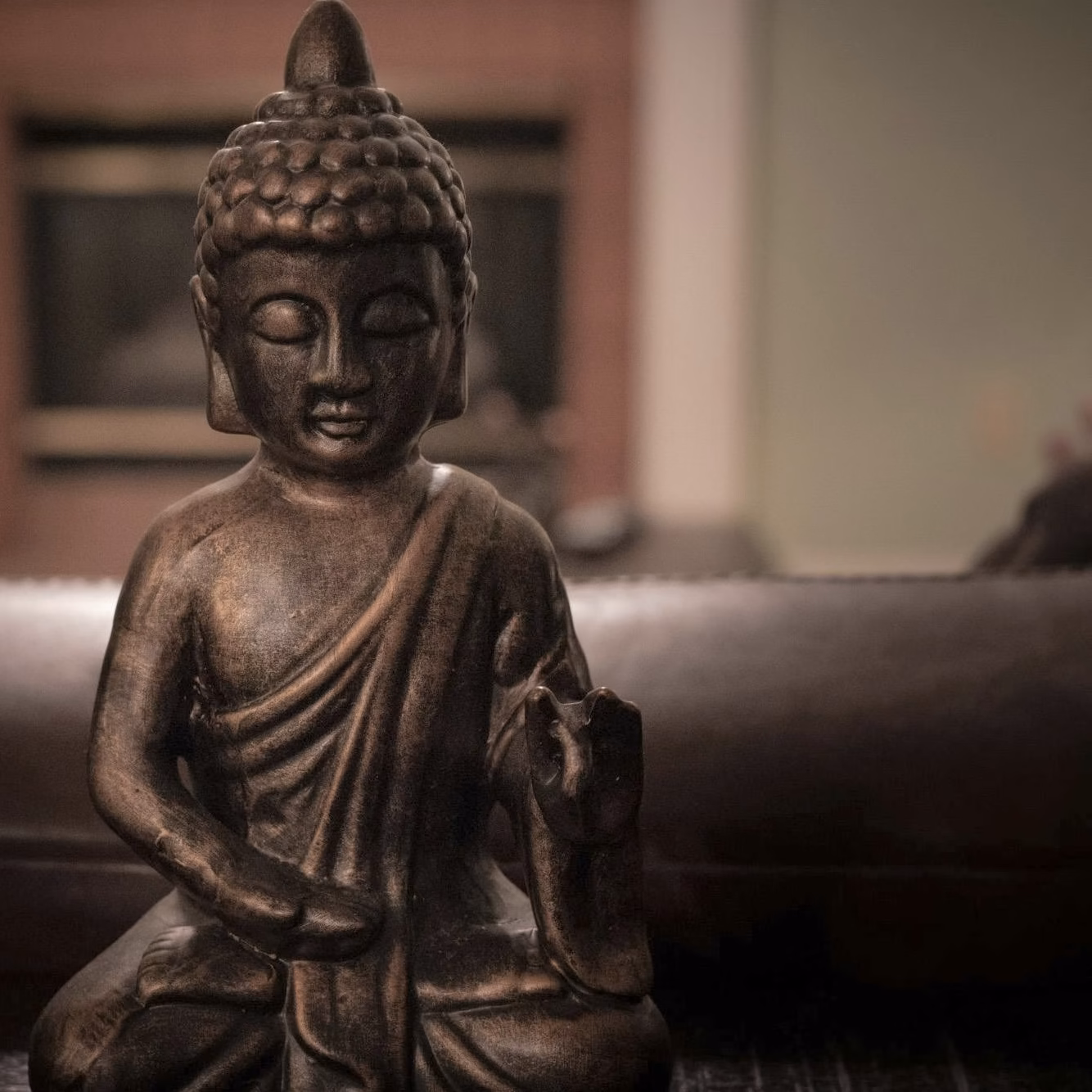 Bronze seated Buddha statue in a quiet room